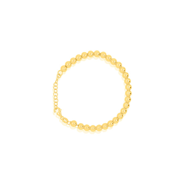 Gold beaded bracelet on a white background