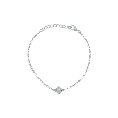 Silver bracelet with a small clover charm on a white background