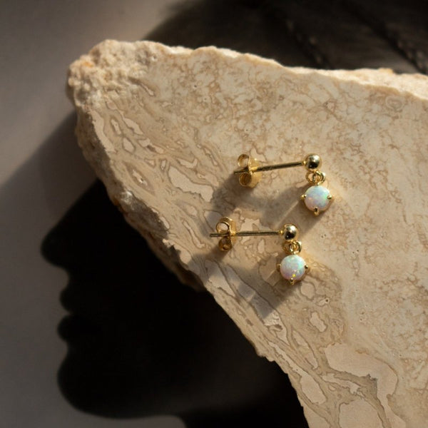 Alexa Drop Stud Earrings// 14k Gold Vermeil x White Opal laid out on rock