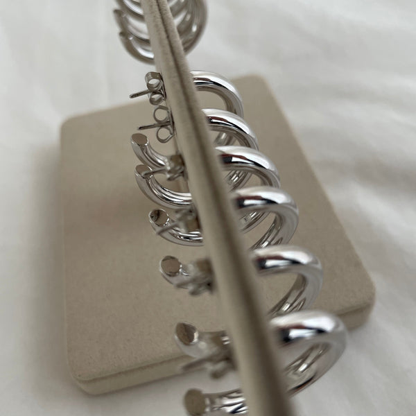 A row of Silver sterling hoop earrings