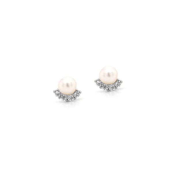 Pair of pearl earrings with silver accents on a white background