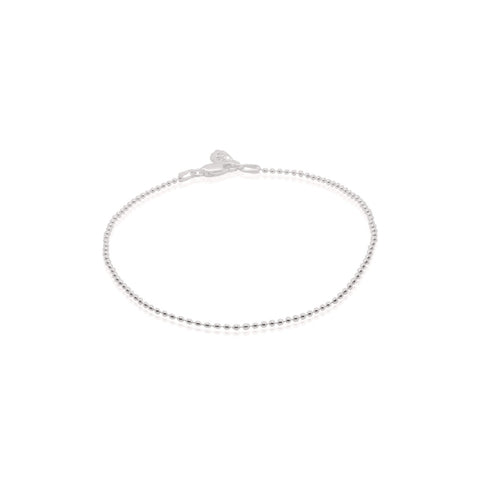 Silver beaded anklet on a white background