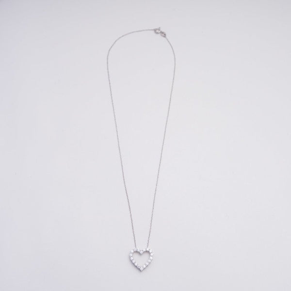 Silver heart-shaped pendant necklace on a light gray background