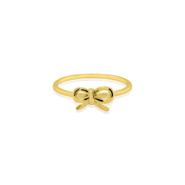 Gold bow-shaped ring on a white background