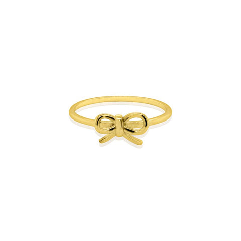 Gold bow-shaped ring on a white background